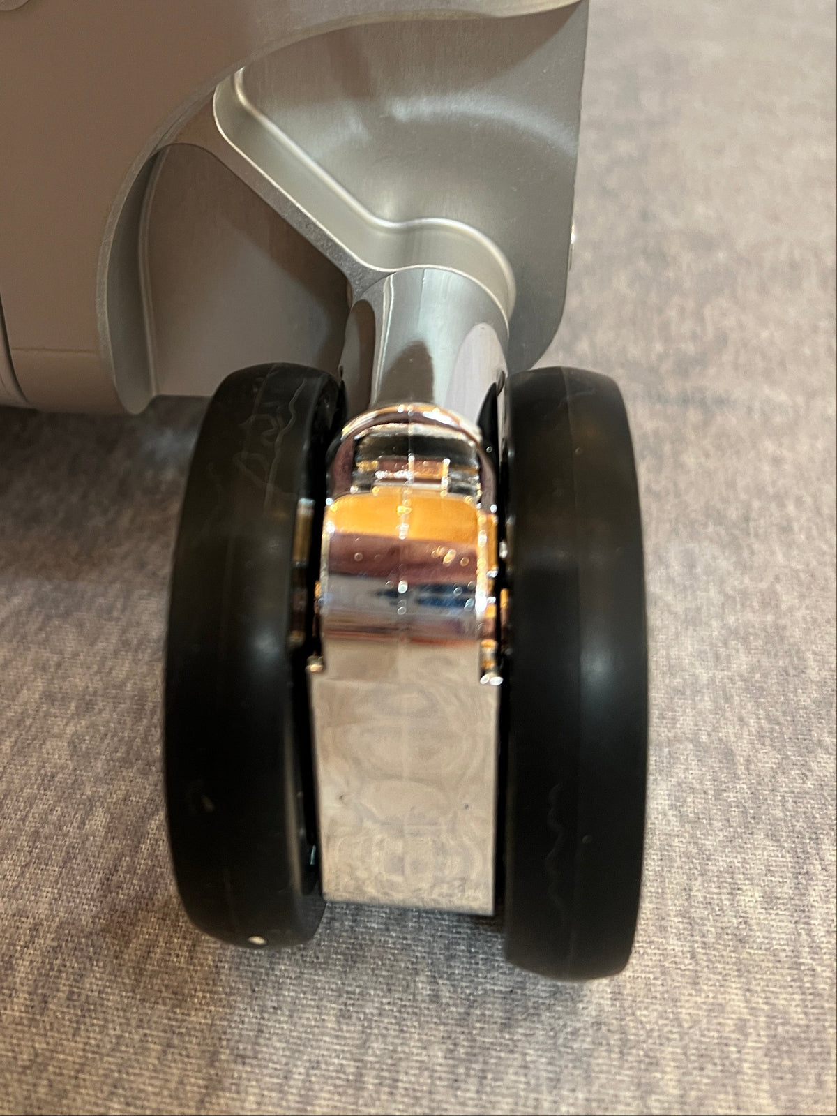 Dual wheel luggage castor assembly for 4-wheel stand up roll aboards.