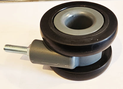 Dual wheel luggage castor assembly for 4-wheel stand up roll aboards.
