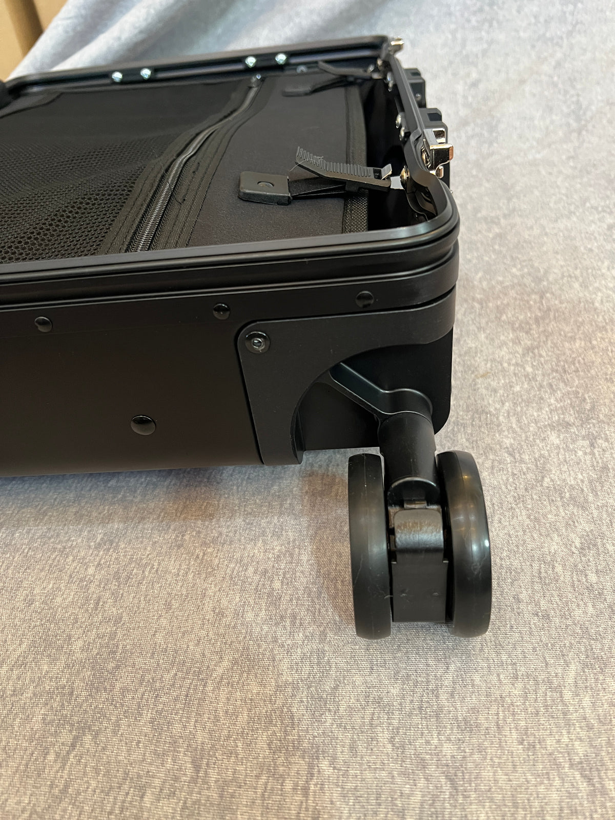 Dual wheel luggage castor assembly for 4-wheel stand up roll aboards.