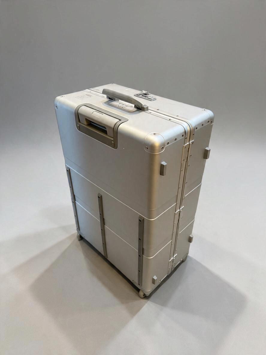 Paradox Aviation 30-inch GEN2 silver metal check-in luggage with four wheels, retractable handle, and cargo tracks.
