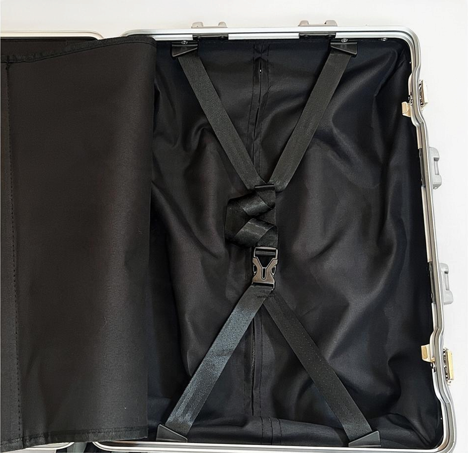 Interior of Paradox Aviation 30 inch GEN2 Frequent Flyer suitcase showing black lining and adjustable tie-down straps