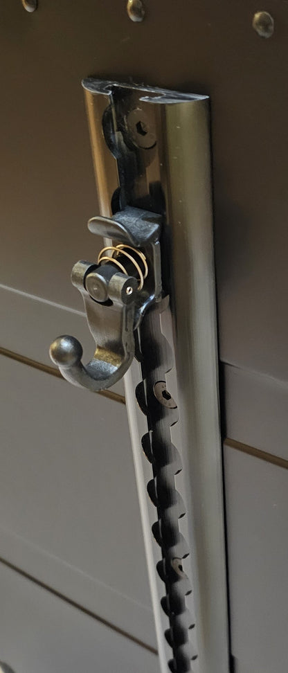 Paradox Aviation cargo track with a black metal spring-loaded hook attached for securing flight crew luggage