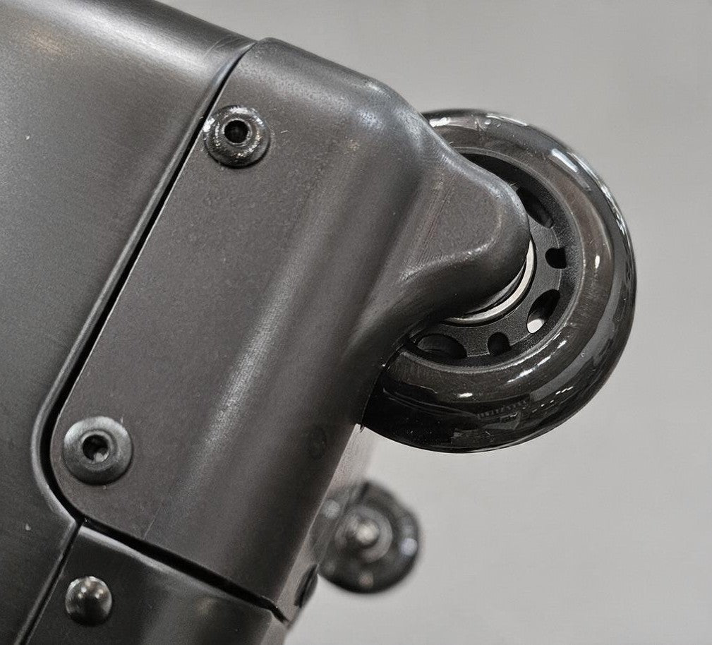 Close-up of the durable matte grey wheel assembly on a Paradox Aviation GEN2 professional flight crew check-in case.