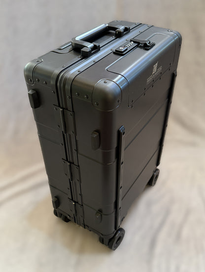 Paradox Aviation 22-inch GEN2 Frequent Flyer hard-shell carry-on luggage in dark sky matte black with four wheels.