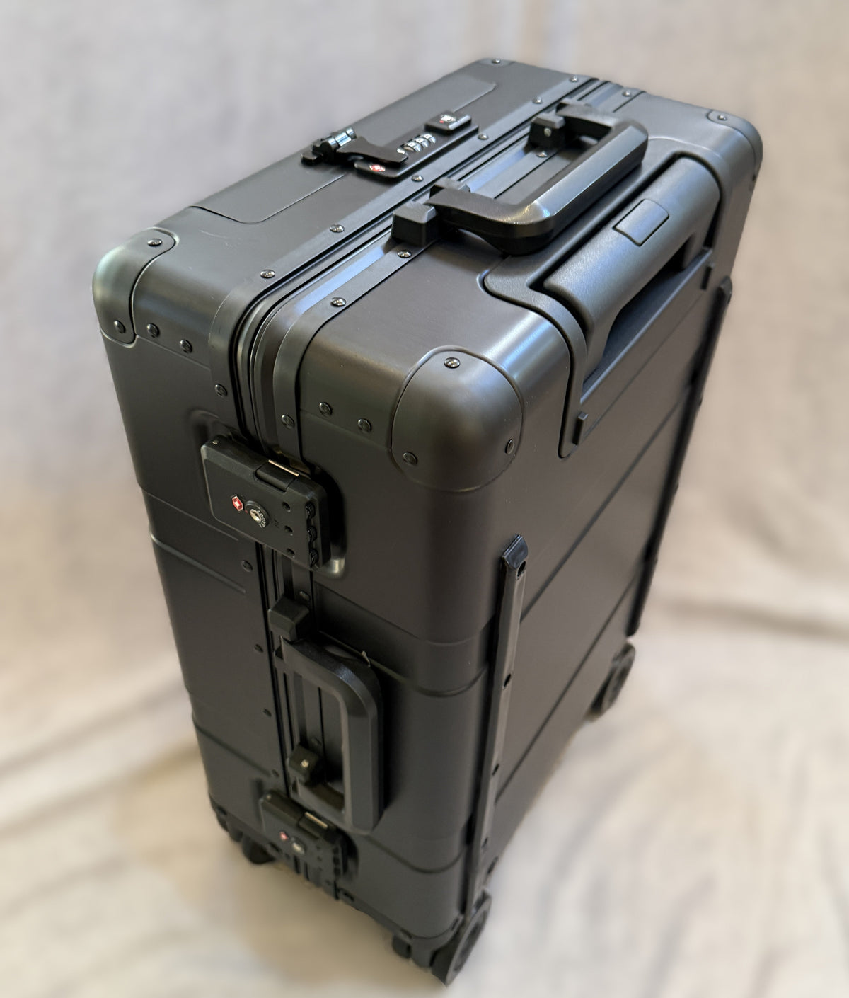 Paradox Aviation 22-inch GEN2 Frequent Flyer carry-on suitcase in dark sky matte black metal with four wheels and TSA lock.