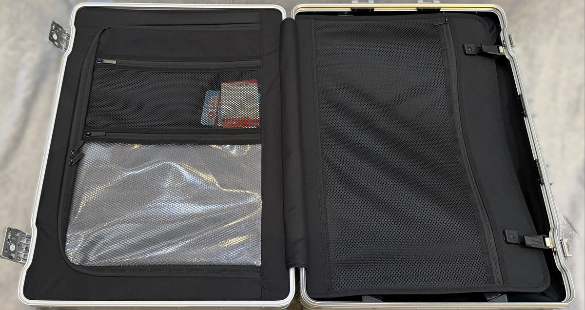 Interior view of Paradox Aviation 25 inch GEN2 Frequent Flyer luggage featuring black mesh pockets and wet pouch