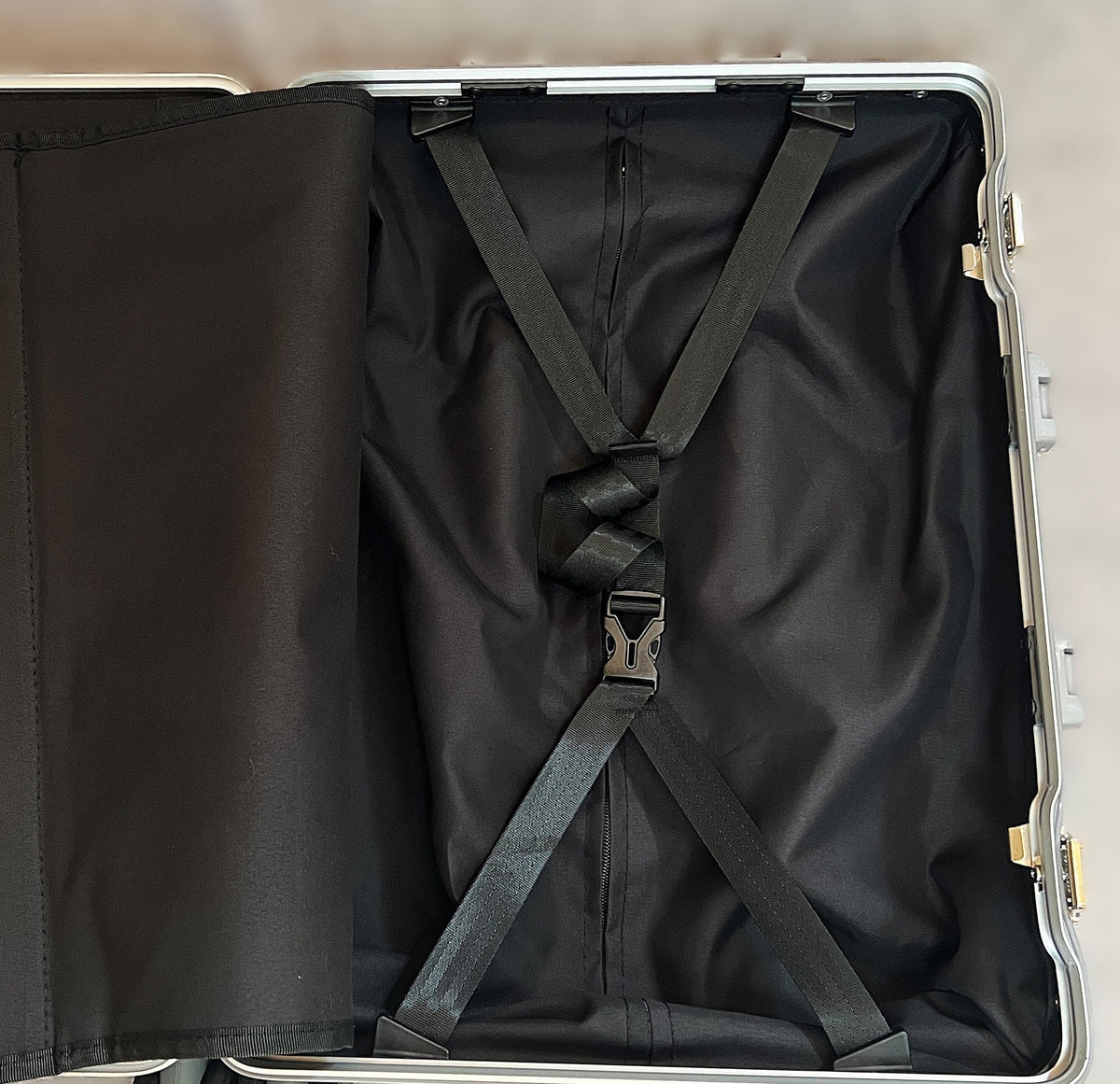 Interior of Paradox Aviation 22 inch GEN2 Frequent Flyer carry-on suitcase featuring black lining and tie-down straps