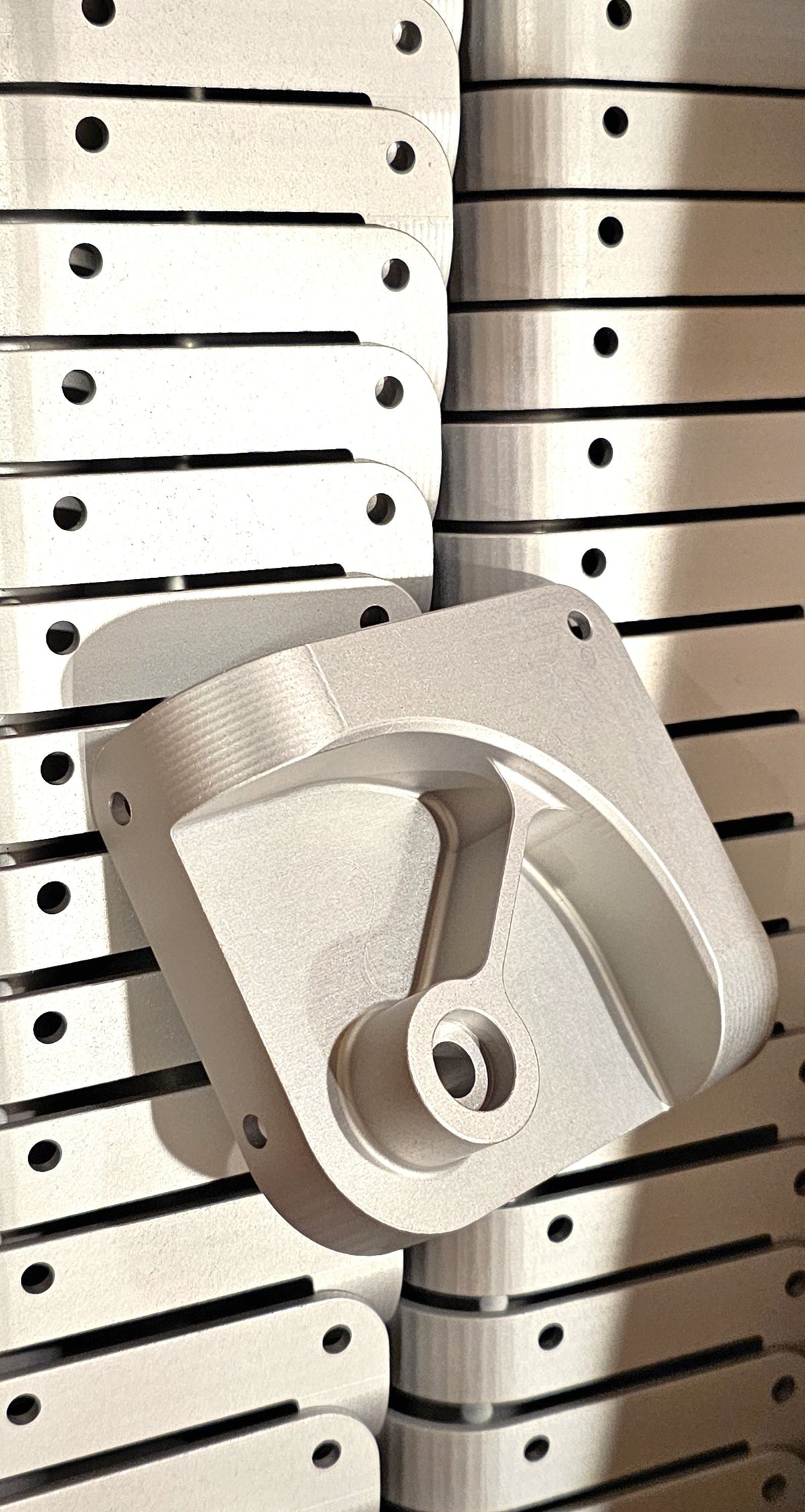 Paradox Aviation GEN2 luggage component, a stack of precision-machined silver metal corner guards for travel cases.