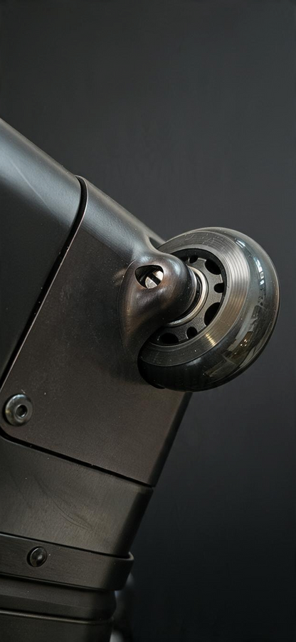 Close-up of a durable matte grey wheel on a Paradox Aviation GEN2 30-inch check-in luggage case.