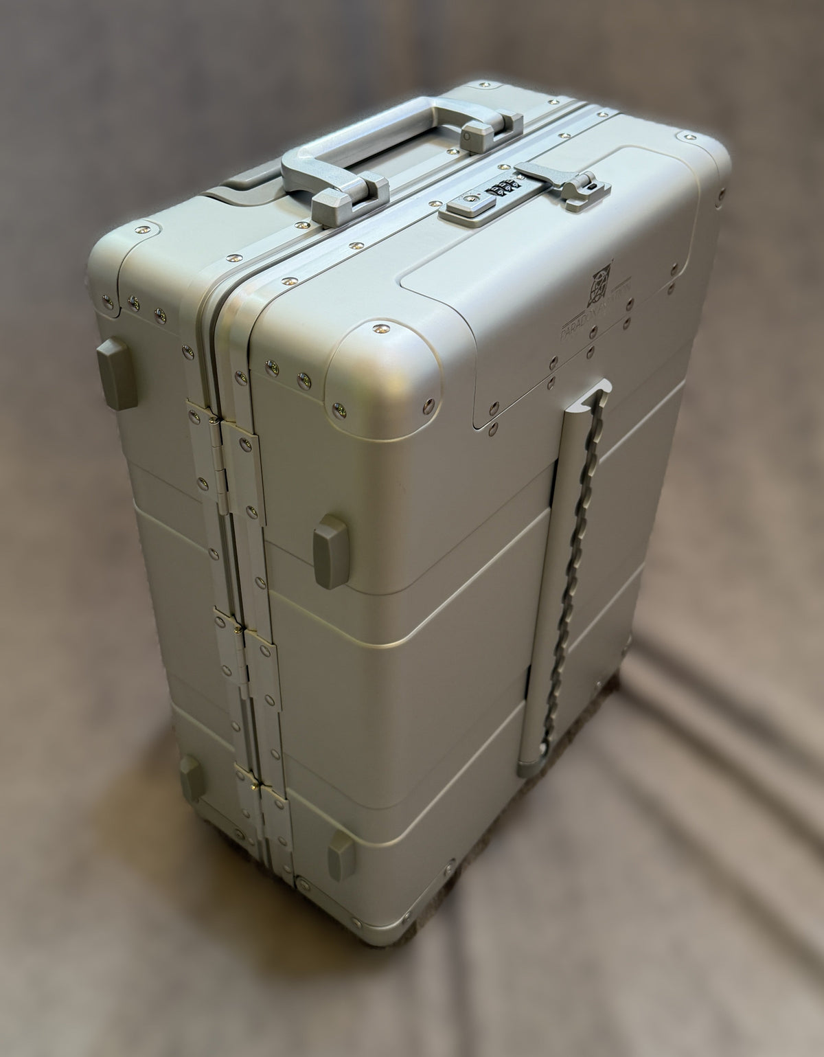 Paradox Aviation 22-inch GEN2 silver aluminum flight crew roll aboard suitcase with a front cargo track and hinges.