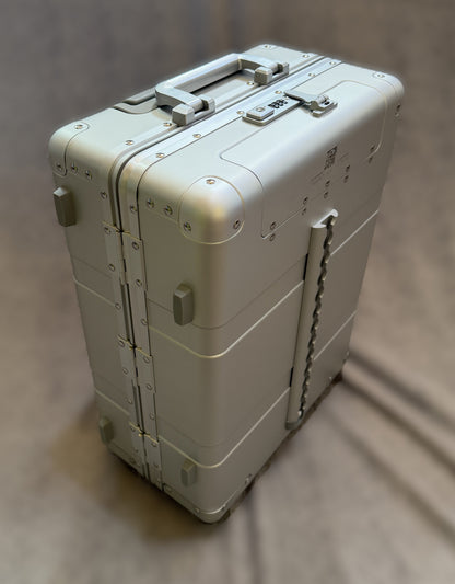 Paradox Aviation 22-inch GEN2 silver aluminum flight crew roll aboard suitcase with a front cargo track and hinges.