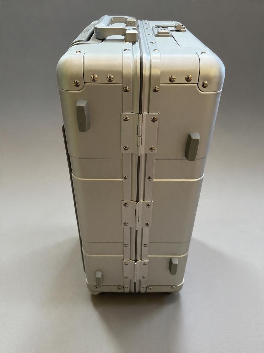 Side view of a silver Paradox Aviation GEN2 30-inch professional flight crew check-aboard luggage case with hinges.