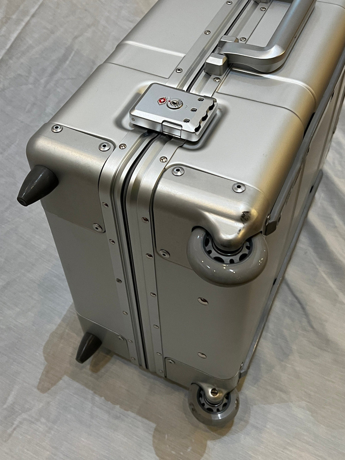 Paradox Aviation 25-inch GEN2 silver metal flight crew roll aboard suitcase with matte grey wheels and TSA lock