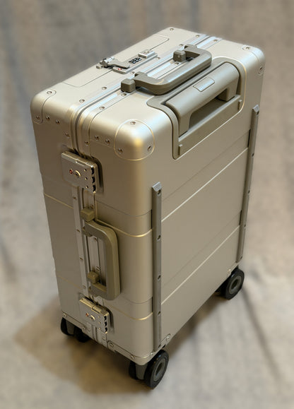 Paradox Aviation 22-inch GEN2 Frequent Flyer hard-shell carry-on suitcase in starlight matte silver with matte grey handles.